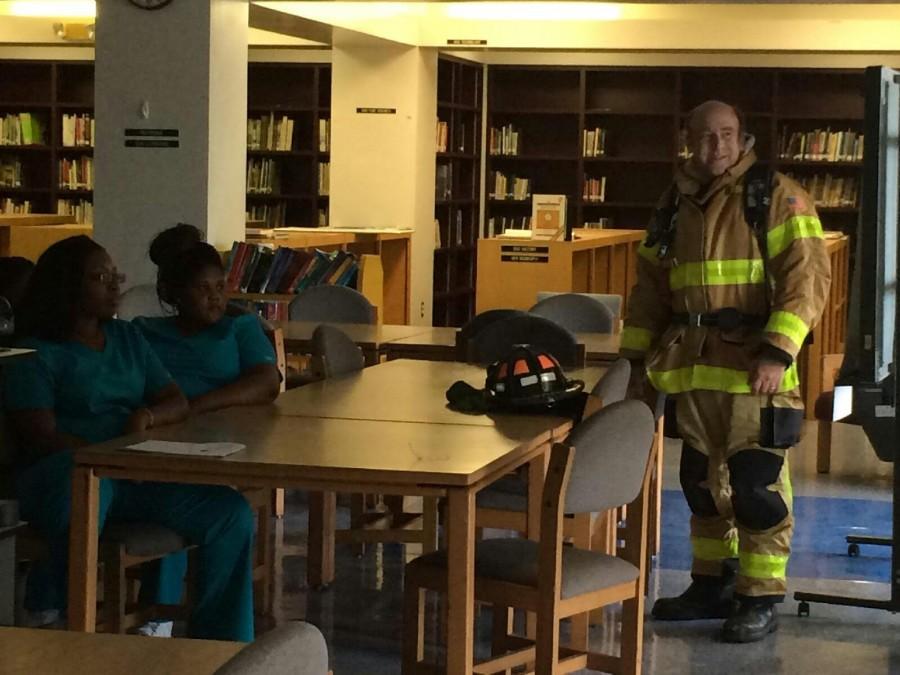 REAL-WORLD SCENARIO: Students enjoyed a simulated emergency scene in the Media Center with Palm Beach County Fire Rescue Capt. Craig Pruzansky. “It was really interesting,” said Jasmine Felix, a junior  in the Medical Academy. “It was the best educational experience yet.” 

