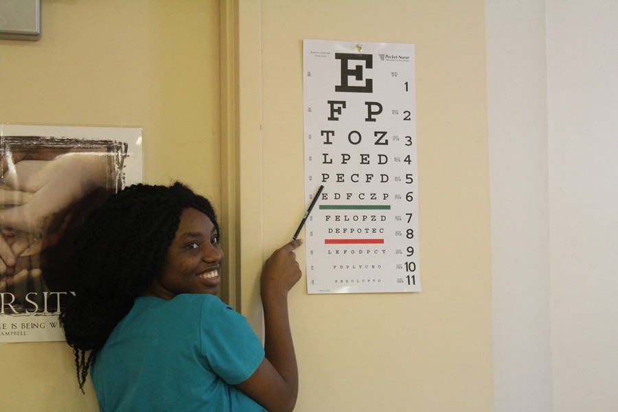 OK, LETS SEE: Rose Telisme, a senior in the Medical Academy, testing students eye vision during the health screening and educational day. The event was operated by our very own LPN, Allied Health and EMR students, said instructor Rebecca Blair, adding that the results included 83 students trained in Hands Only CPR, 71 students screened for sun damage and educated on sun safety, and 116 vision screenings.