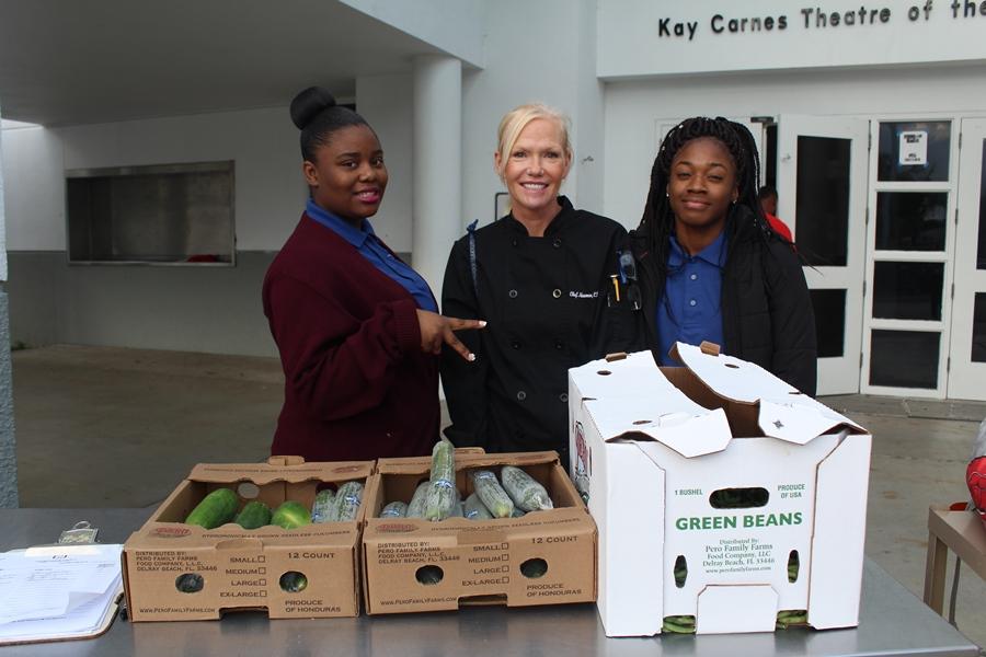 GOING GREEN: Chef  Tammy Newman and some of her Culinary students gave fresh cucumbers and green beans to families for the Thanksgiving holiday.