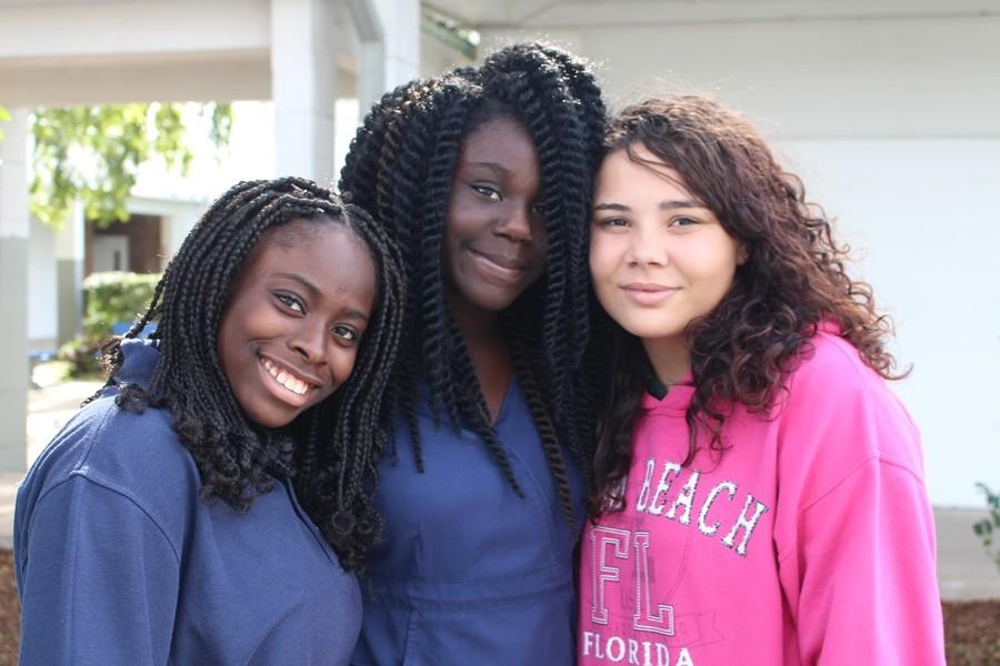 WE ARE UNIFIED: (L-R) Freshmen Raya Holmes of the Pre-Law Academy, Veltenna Estiverne in the Medical Academy and Angelita Torres in Pre-Engineering ignore differences and join together as one to show their friendship.