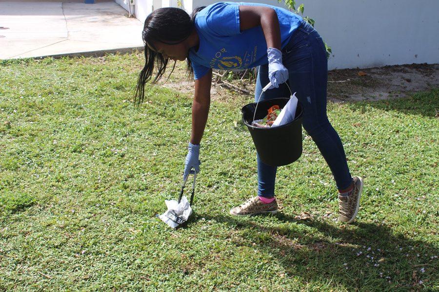 NEAT AND TIDY: Tanoy Thames and her fellow National Honor Society  members continued their campus cleanup project during lunchtime Oct 17. Tanoy, a junior in the Medical Academy, is also the Junior Class president and the student representative on the School Advisory Council. 