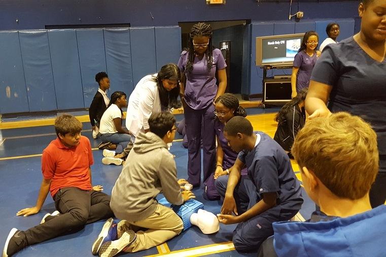 IN THE GYM: The Medical Academy does it again, this time with Nurse Madappurakals students teaching Coach Fritzs Physical Education students how to make a life-saving difference by performing hands only cardiopulmonary resuscitation.
