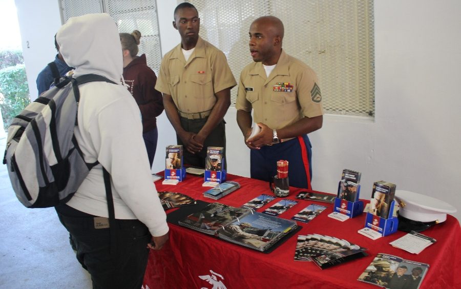 SIGN UP TODAY: Inlet Grove graduate and now Staff Sgt. Ronald Williams, left, and fellow Marine Corps recruiter Sgt. Reed invite students to join and secure their spot.