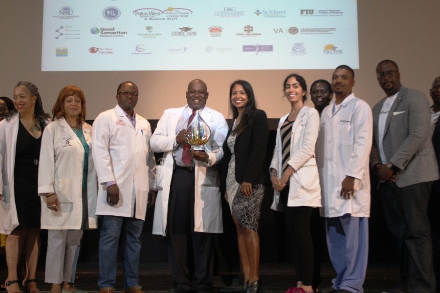 STUDENTS MEET HEALERS: Roger L. Duncan III (center), immediate past president of the T. Leroy Jefferson Medical Society, poses with the keynote speaker, Florida Surgeon General and Secretary of Health Celeste Philip (to his left), along with other members of the Medical Society, during the Fifth Annual Health & Science Stars of Tomorrow Career Symposium at Inlet Grove.
