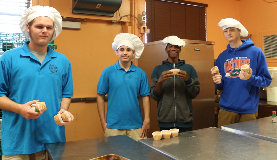 UP TO THE CHALLENGE: Noah Applebley, from left, Philip Waldbert, Corey Holmes and Steven Beier show what they can come up with in Chef Newmans Culinary Academy kitchen. They learned to make cupcakes and how  to make them different from others.