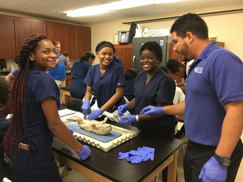 ALL SMILES: From dissecting pigs to taking pictures inside an aquarium, Dr. Landron and Dr. Tellezs medical students experienced hands-on learning in a different way Nov. 3 at the South Florida Science Museum in West Palm Beach.
