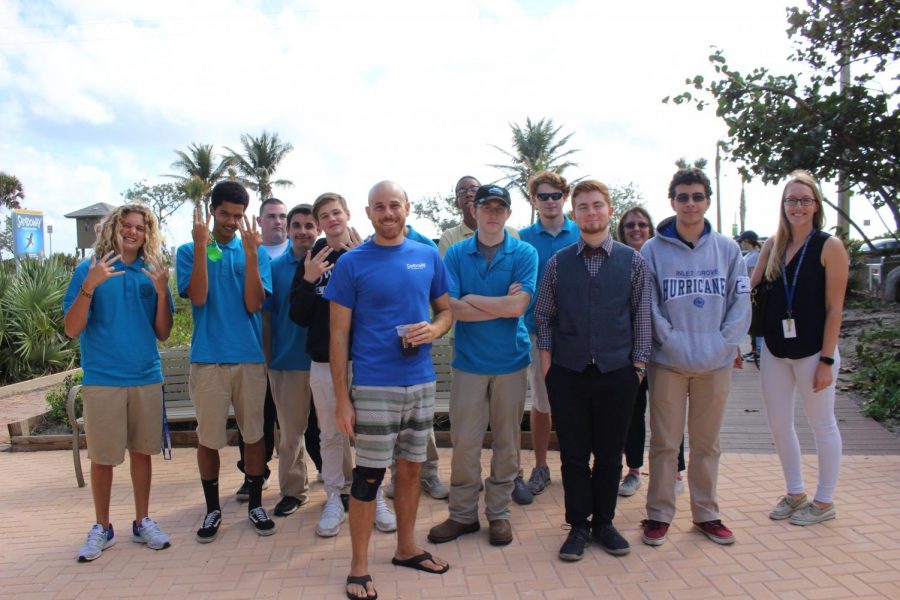 ITS O-FISH-AL: The Marine Science students along with their teacher, Ms. Rose, band together to take a picture with their tour guide, Evan Orellana.