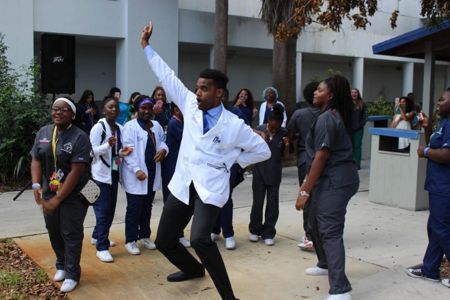 LUNCHTIME PARTY: Showing that medical specialists also can be down to earth, Emmanuel L. McNeely, Florida Atlantic University MD candidate, busted a move with students who attended the 6th Annual Healthcare & Science Stars of Tomorrow Career Symposium. The Inlet Grove Drumline also was in the house. 