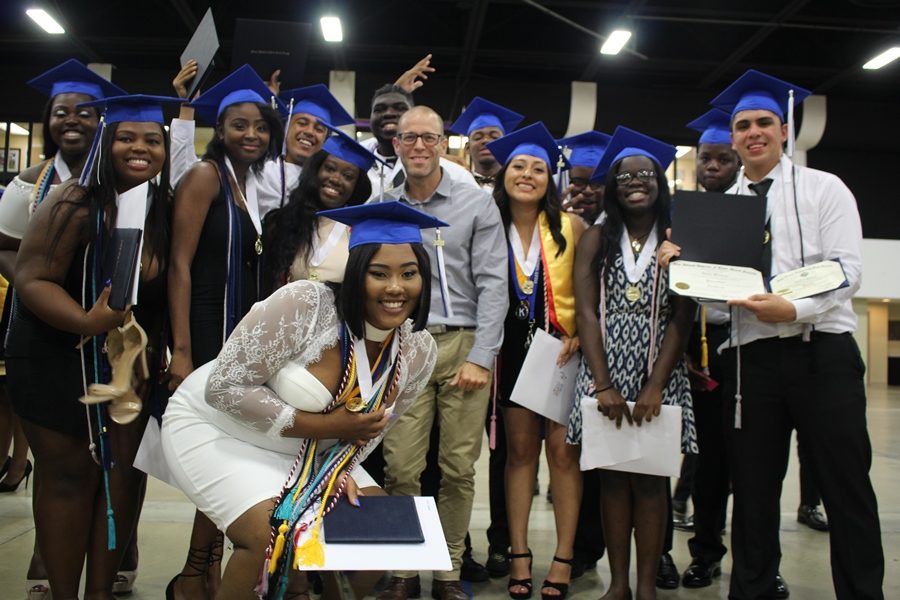 NEW CHAPTERS: As the Hurricanes Class of 2k18 prepared to walk the stage, last time hugs and tears were shared. Mr. Goldstein here is surrounded by some of his accomplished TV & Film Production students following the graduation ceremony held May 21 at the South Florida Fairgrounds. 