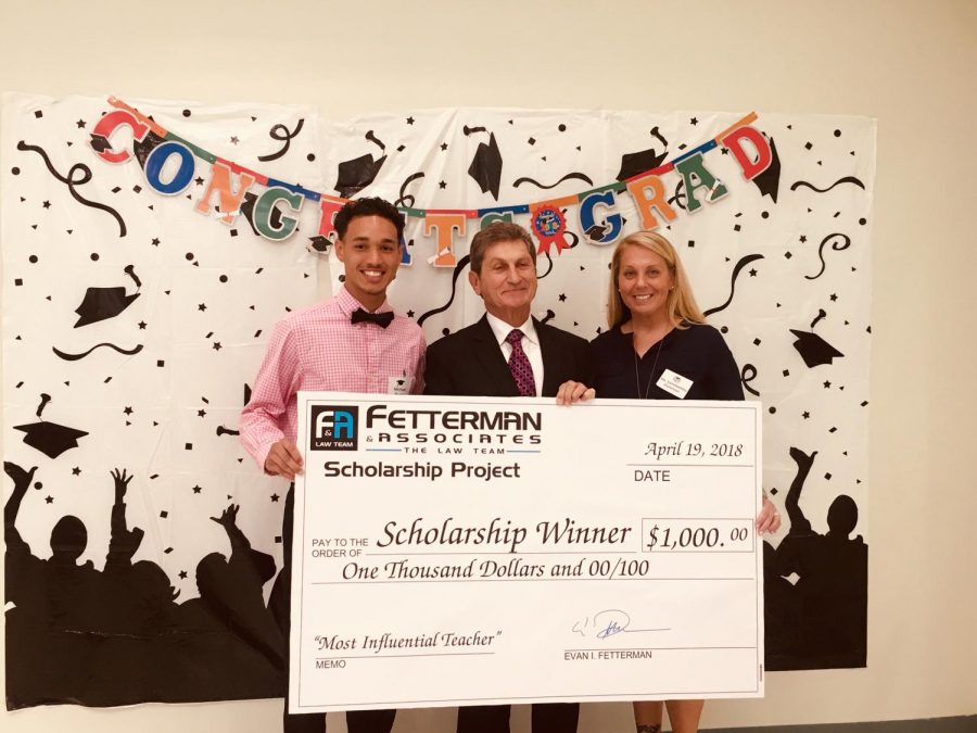 FREE COLLEGE MONEY: Receiving a $1,000 scholarship from Fetterman and Associates is Michael Nunez for his entry on his Most Influential Teacher, Coach Donovan, during a ceremony in North Palm Beach.