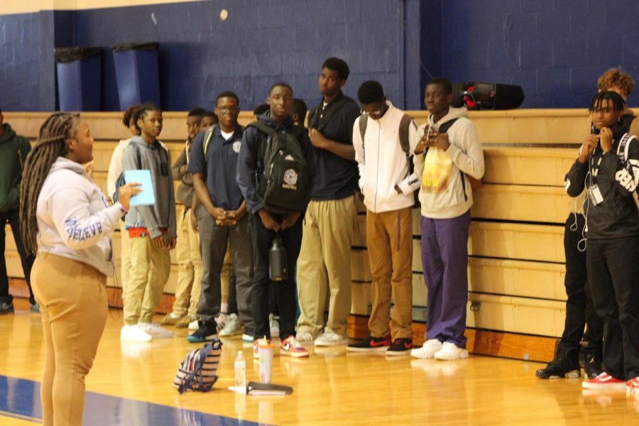 LISTEN UP: During lunch, students came together in the gym to get information about the upcoming basketball season from the head manager, Flo Francois, Aug. 21.
