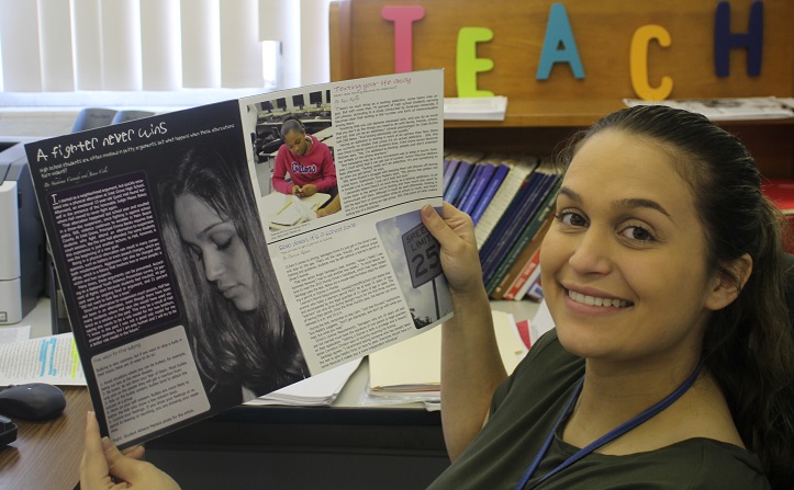 THROWBACK THURSDAY: Mrs. Manera, who teaches Pre-Law, poses with Inlet Groves Forecast magazine of 2011 that features her back when she was a student here. Mrs. Manera Goes from student to teacher in seven years.