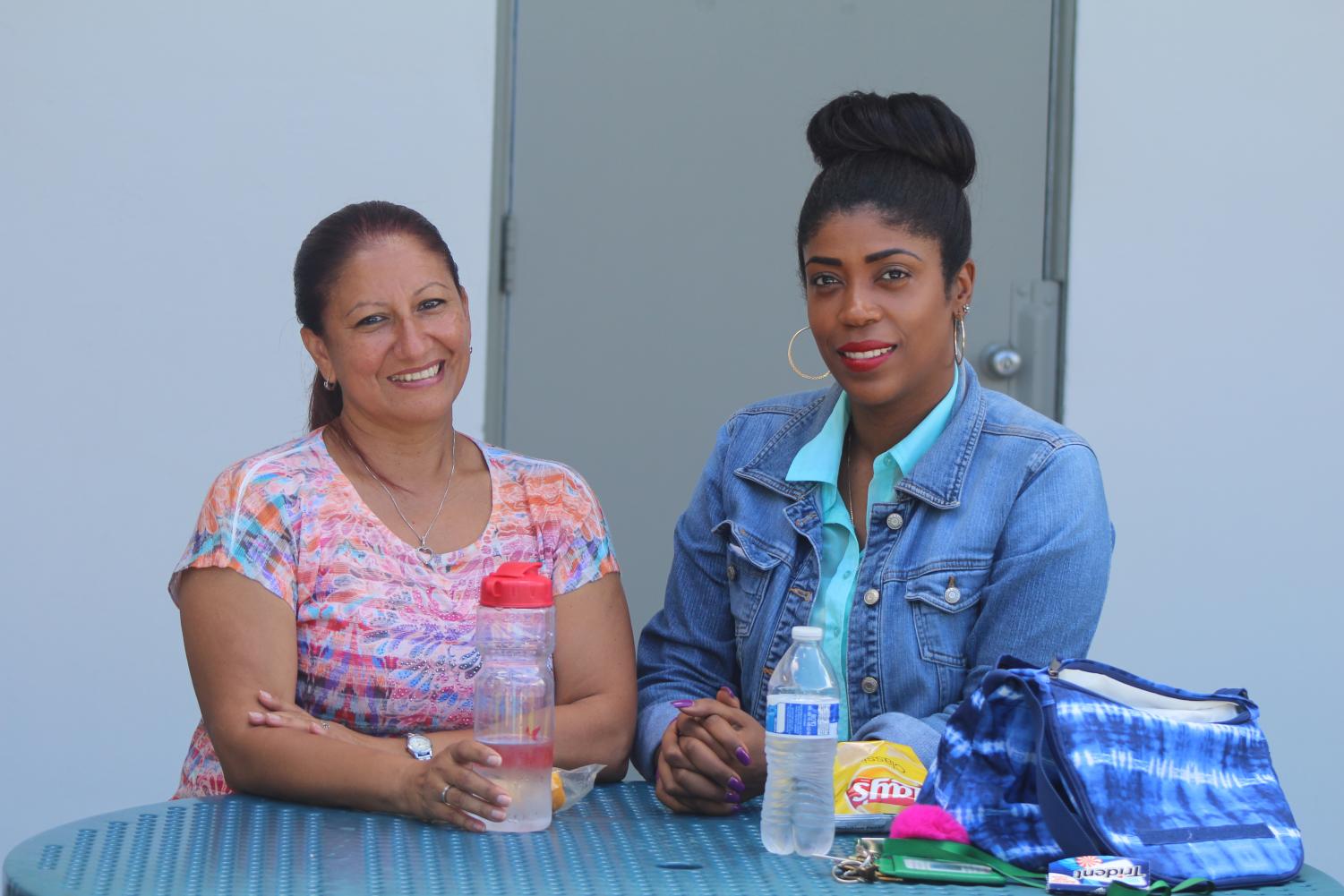 READY TO EAT: Administrative assistants Ms. Santos and Ms. Espinoza get together to enjoy their midday meal at their usual spot in the middle of the courtyard.
