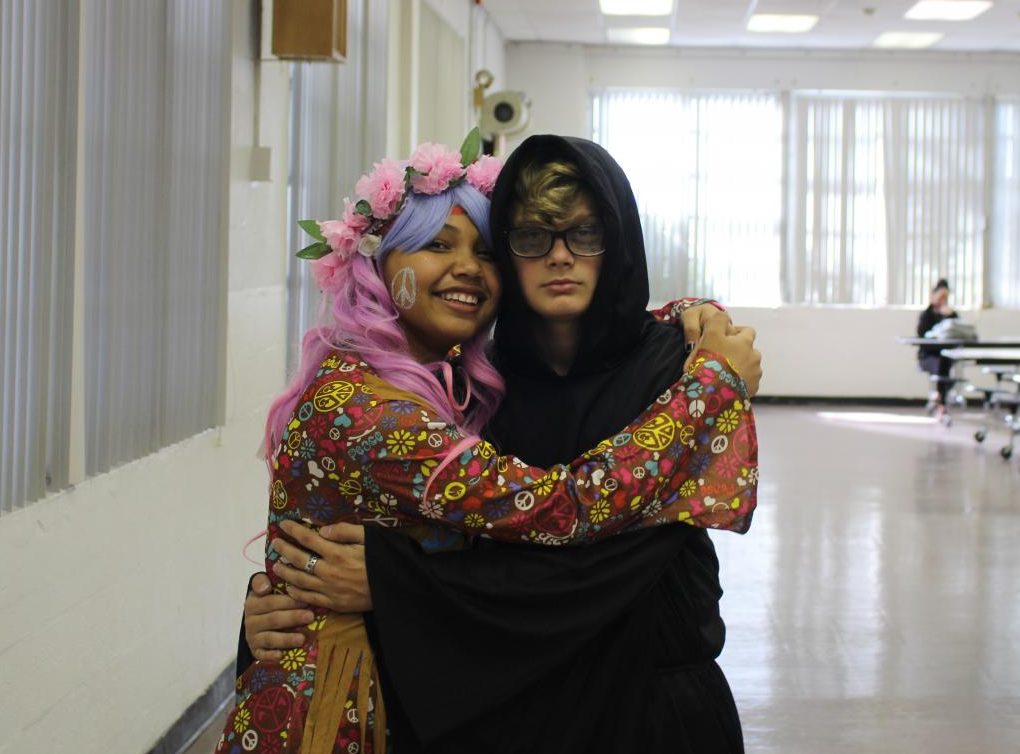 PEACE, LOVE, DEATH? Freshman couple Rayanne Williams and Jacob Zukas dressed as a colorful hippie and depressed grim reaper, celebrated their Halloween with a hug.
