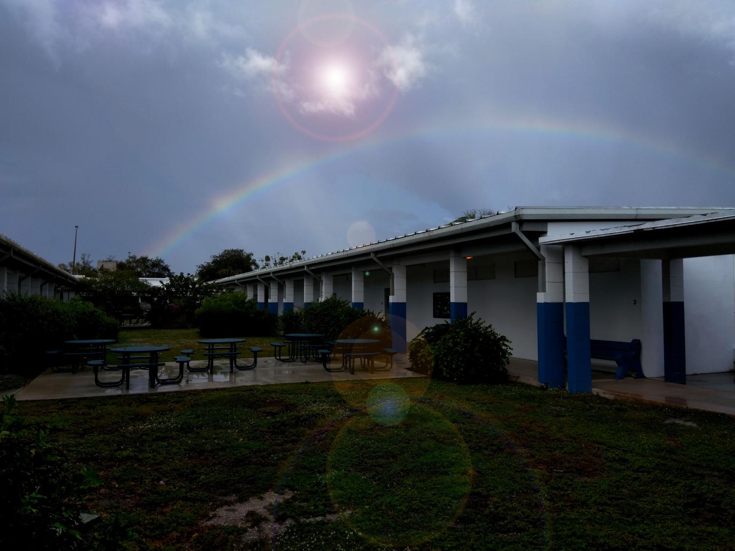 COMES THE RAINBOW: Humid and hot after a series of morning showers, Inlet Grove's campus is cradled beneath a shining sun and a radiant rainbow arch.