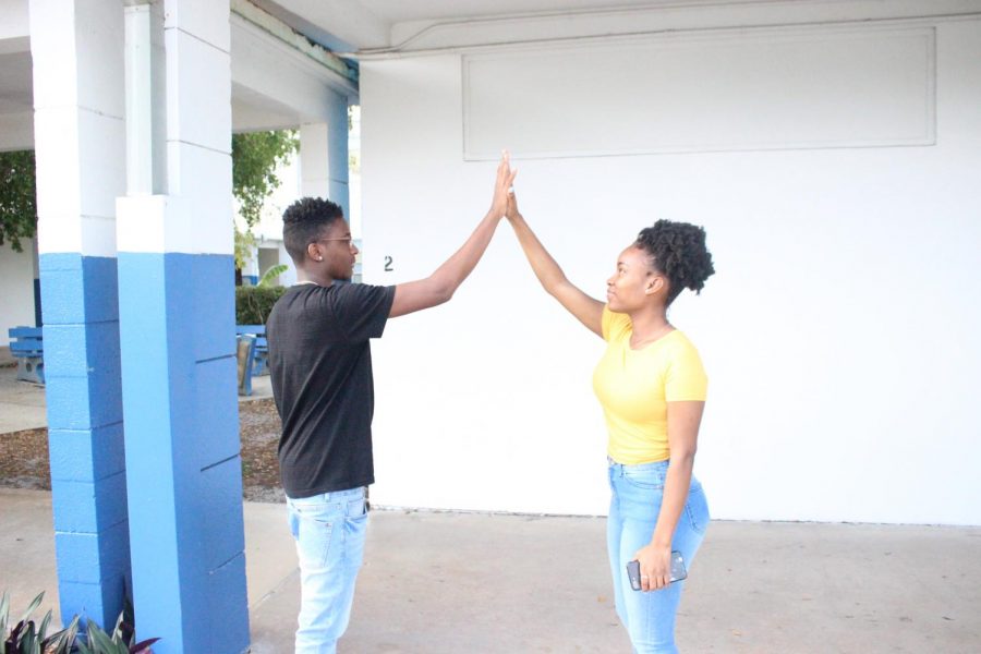 DOWN LOW: You have all day to show off your  and hand shakes, because its National High Five Day.Students (left to right) Johnathon Hunter and Hannah Snow are showing off theirs for today.