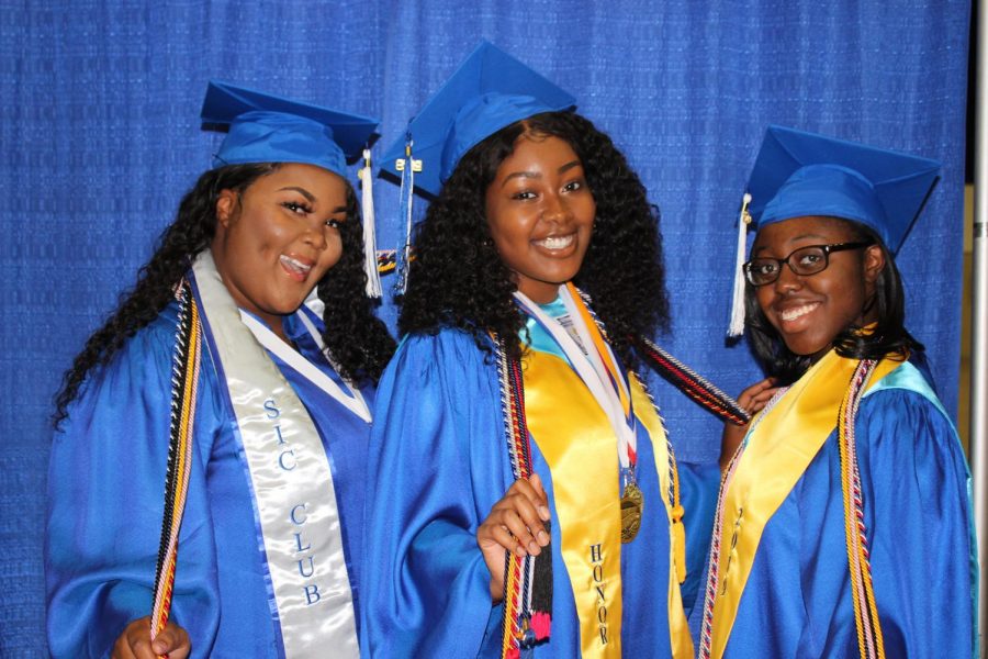 HELLO WORLD: Tears were shed as hugs were being given to the Class of 2019 as they walked the stage May 16, at the South Florida Fair Grounds Expo Center. Before the ceremony English Teachers, Ms. Mathias and Mrs. Cartwright prepped the seniors on how to stand, walk and conduct themselves throughout the event. Senior Class President Zenia Topps looked back on the highlights of her four years with her fellow classmates, keynote speaker and former Inlet Grove teacher Mr. Graham spoke on how to value this moment and Valedictorian Robelle Jean gave an inspirational speech. From left, Flolaine Francois, Tatyana Moise and Ruth-Ann Walker. 