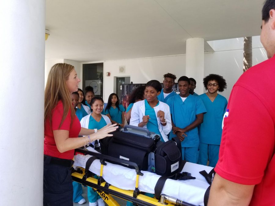 SAVING A PATIENT: Medical academy students joined the AMR ambulance Sep.18 on hooking the patient up to the vital signs monitor and loading the patient on and off the stretcher.