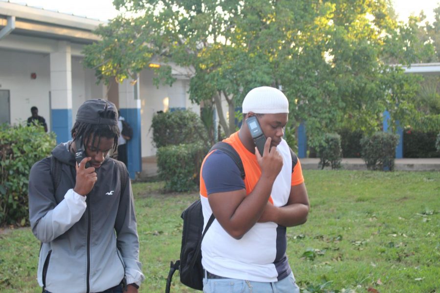 BLAST FROM THE PAST: Today at Inlet Grove it was a 90s throw back when 
Maurice Law and Geovonni Wilson were using flip phones from the 90s .