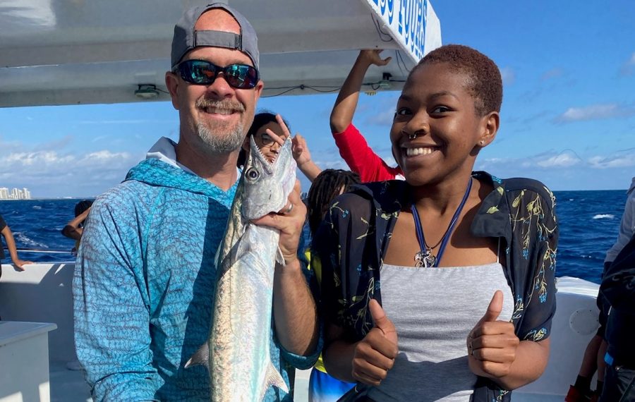 EXPLORING FOR FUN: Mr. Rice accompanies his students in the Adventure Club on a fishing field trip and celebrates Stacey Paul's, birthday, a student in the Maritime Academy.