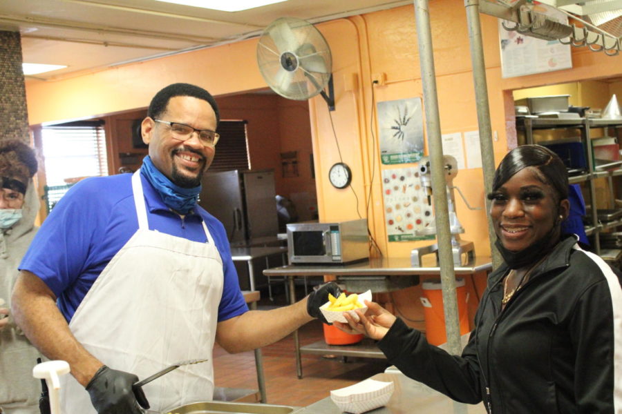 HOORAY: Today the students with at least 200 Hero Points got to receive a special incentive during lunch that was provided by the staff. Lowicha, a senior in the Medical Academy gets the fries for the COO, Mr. Sims.