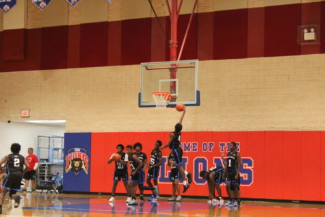 HE SHOOTS, HE SCORES: Junior Varsity Canes were warming up their layups prior to their game against Kings Academy on November 29.
