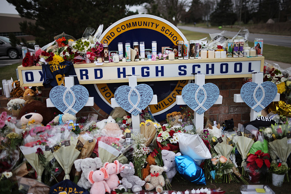 MEMORABILIA: Stuffed animals, balloons, and flowers left in front of Oxford High to honor the fallen victims.