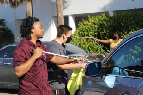 PARTNERSHIP: Students participate in washing teachers, students and  community cars to fundraise.