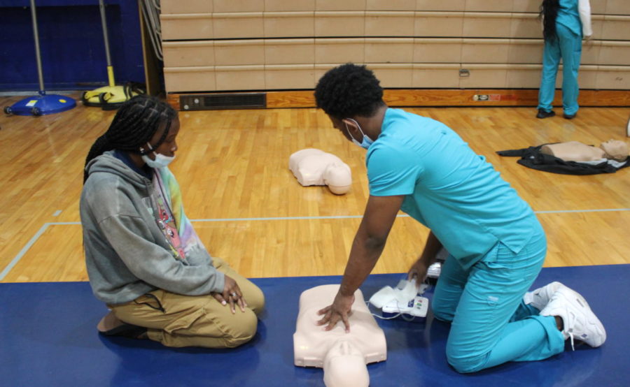 SHOWING ACTION:  The Medical Academy partnered up with Coach Fritz PE class to teach them on the importance of knowing CPR.