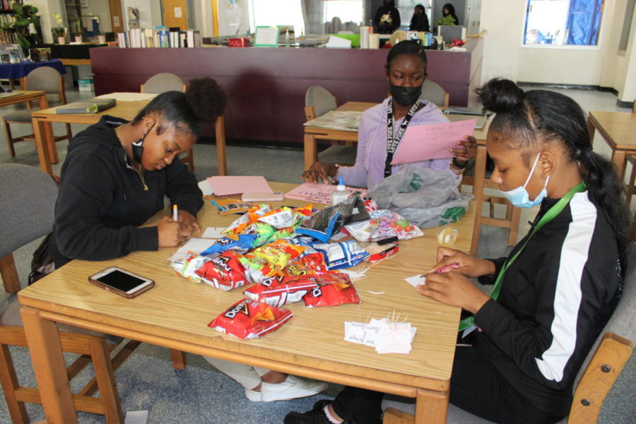 COMMITMENT: JaNiaya Jean-Baptiste, Laushana Jasmin and Lamareonna Weatherton creating posters for their Prom Queen campaign.
