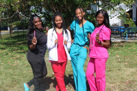 CHECK UP: Seniors participated in career day for Spirit Week. Lowicha Augste, left, Klorskyne Laguerre, Dashnika Bureau, and Shenell Robinson wore scrubs to represent their future profession. 