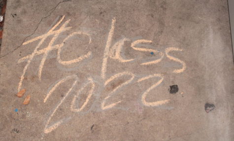 SENIORITY STAIN: In front of the main office, the seniors and some underclassmen used chalk sticks on the floor, leaving names of  seniors, drawings, or a message to them on their second to last day of school.