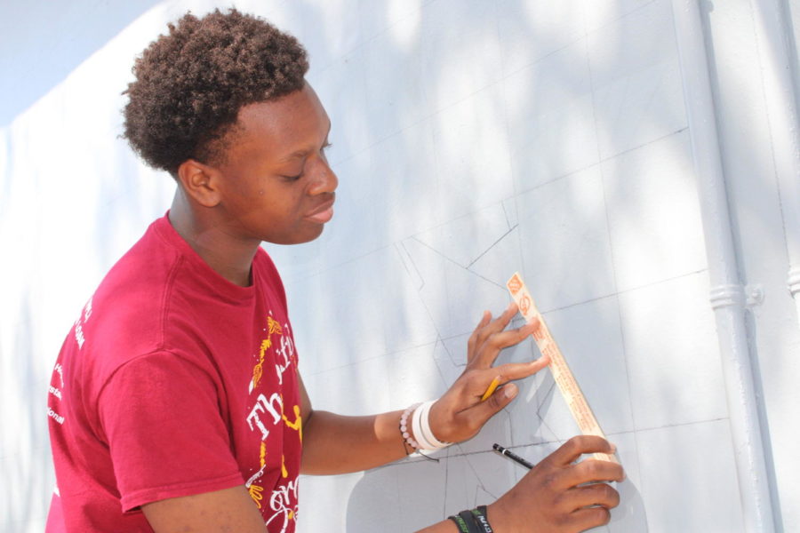 CANE EFFORT: The Multicultural Club led by Jonathan Eugene, are painting a mural by building 2. We are just trying to leave our mark on the school, the mural represents our diversity said Jason Eugene.  