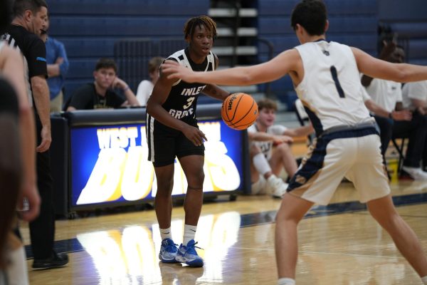 TENSE WIN: The Canes JV and Varsity Basketball team played against West Boca on Dec. 5, going back home with two wins. 