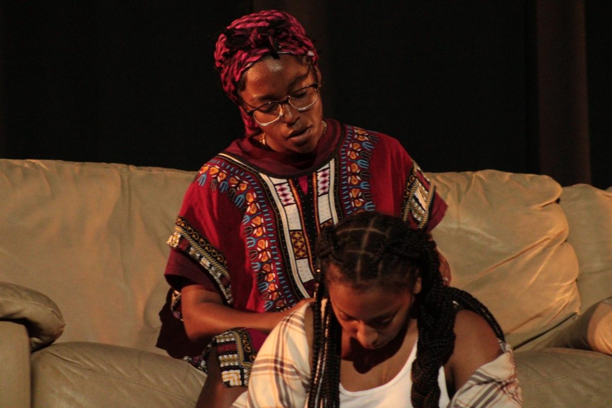 SEEK THROUGH: For the 2nd Black History Month assembly, Breyana Brown, a 12th grader, and 10th grader A’mila Burey played mother and daughter roles advocating the beauty of black skin and hair. 