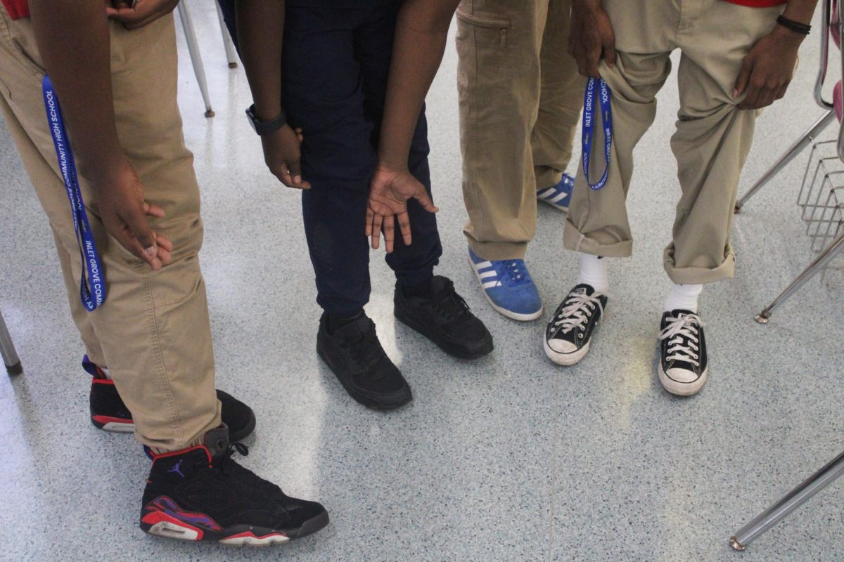 SHEEEESH: Four of Ms. Kirkman's students display their kicks in Mr Morehouse's classroom for a photo scavenger hunt on Sept. 24.