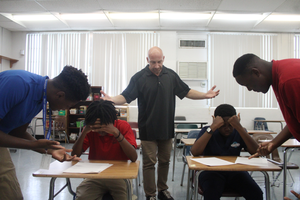 YOU CAN DO THIS: Mr. Morehouse and 2 of Ms. Kirkman's students encouraging their fellow classmates to complete a reading assignment.