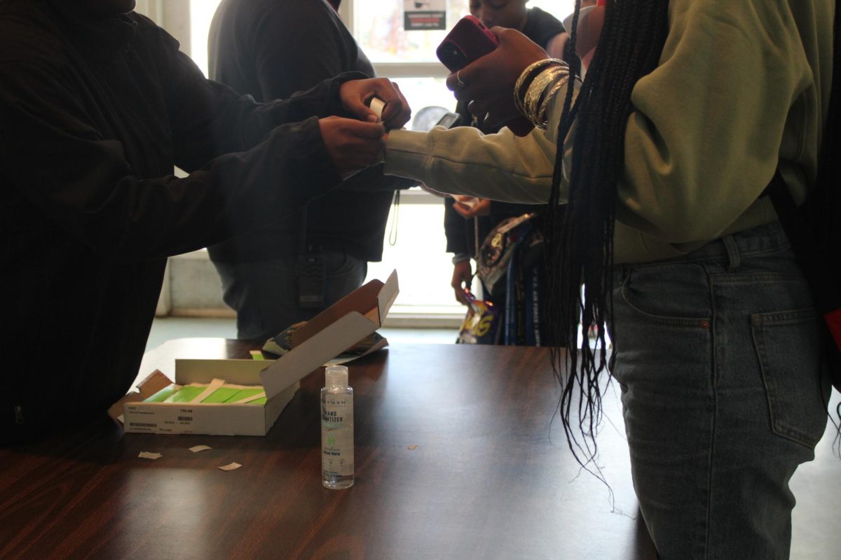 OUT OF NORMAL ATTIRE: The scholars receiving their wrist bands to be wearing something nice.