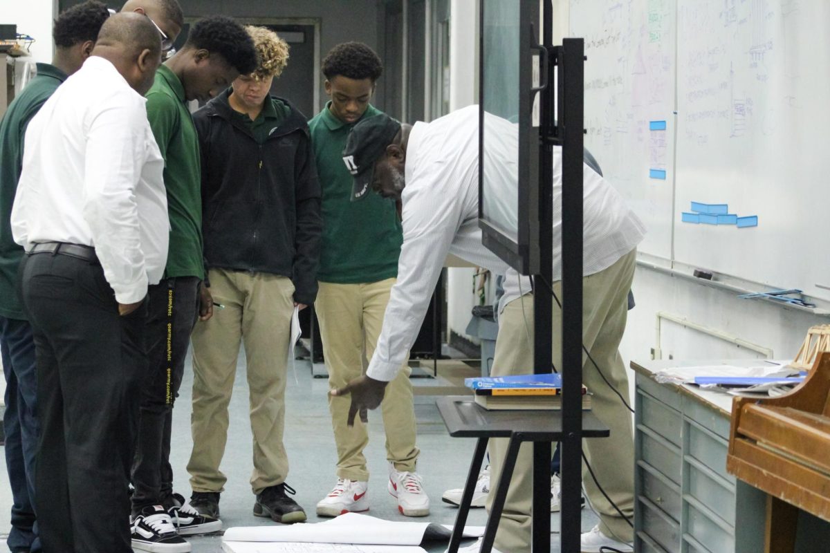 : New Instructor for Pre-Architecture Robert Marshall, teaching students names and symbols on a floor plan. As Clarke Roderick ex-instructor watches by he'll being here at Inlet looking over test and will be teaching the middle schoolers that will come in January. 