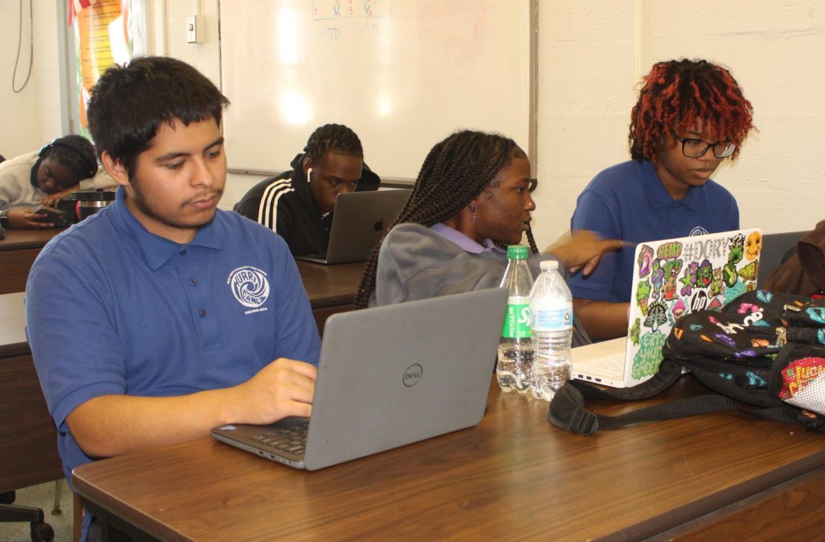 BEST AND BRIGHTEST: Mr. Martinez's students worked in groups of three to help each other learn more about the world of code. 