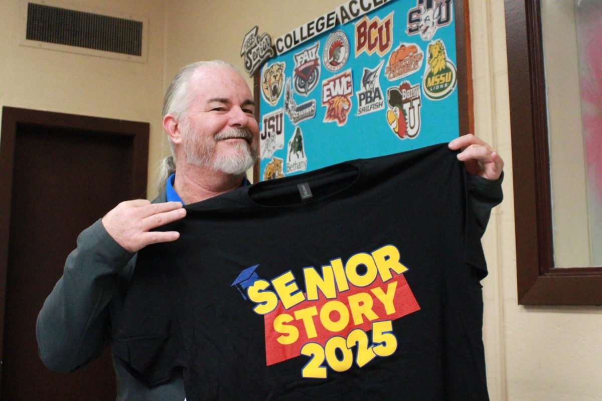 RUN, DON’T WALK: The wait is over senior shirts are in! Scott McDermott, Careers Coordinator for grade 12, holds up a senior shirt, showcasing the long-awaited design for the class of 2025. Make sure your dues are paid, then head to Mrs. Kim’s office to collect yours.