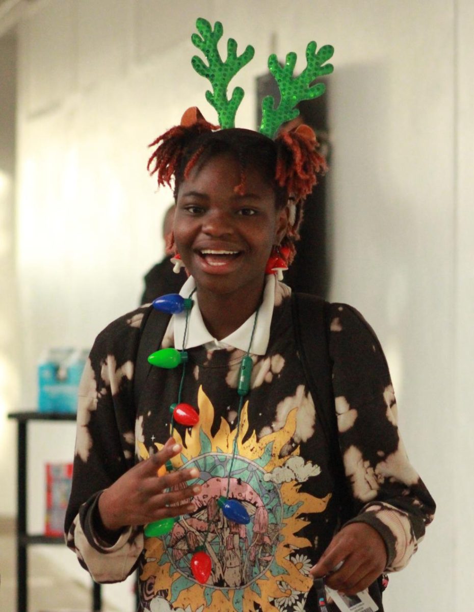 SPARKS OF JOY: Ketia Coleus a Senior in the Pre-Architecture/ Pre-Engineering Academy rocking her reindeer ears and her light bulb necklace.