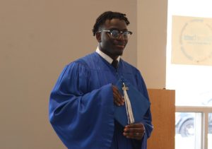 GOLDEN MEMORY: Branskey Luc, a Senior in the Culinary program and other students in the graduating class took their
 in-school Senior yearbook photo on Jan. 9.