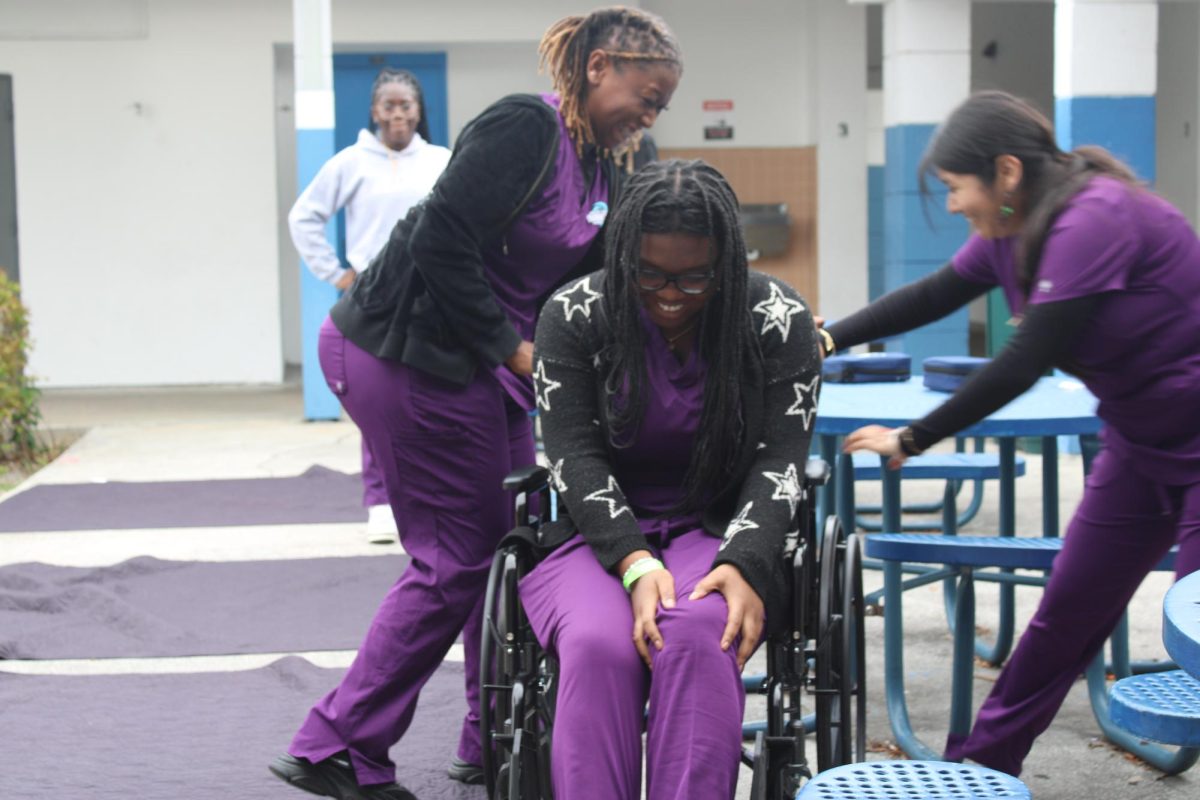 LEND A HAND: Students in the LPN (licensed practical  nursing) program, Sydney Ligonde (middle), Brina Brown(left) and Vanessa Morales (right) share laughs as they practice  medical procedures.