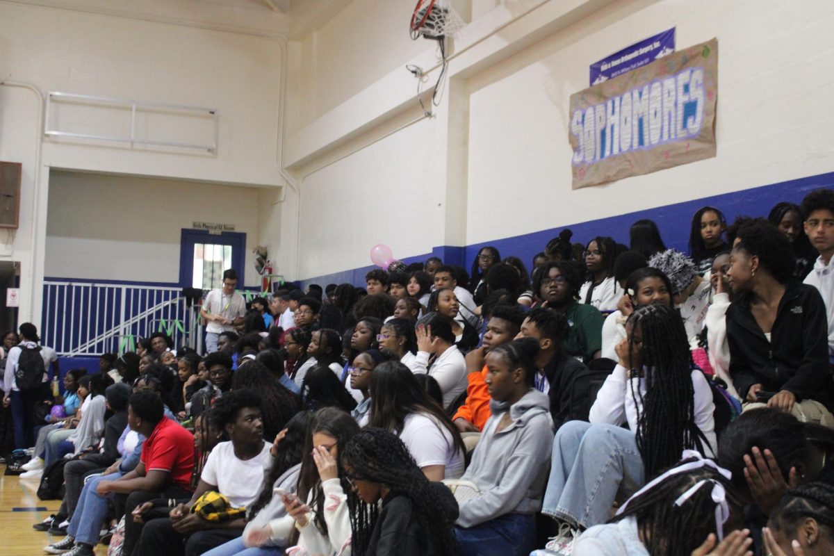 Students sit waiting for the festivities to begin.