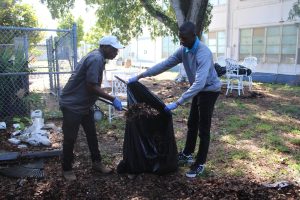 HANDS IN THE GARDEN: During 2nd period, Mr. Burt's Marine Biology class lends a hand to keep our garden strong. Photographed  above are Mr.Burt and  Kareem Coleman