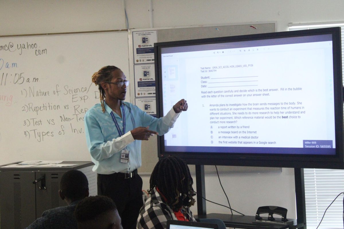 1-2-3 ALL EYES ON ME: Students are paying close attention as Science instructor Mr. Williams reviews the test they took.
