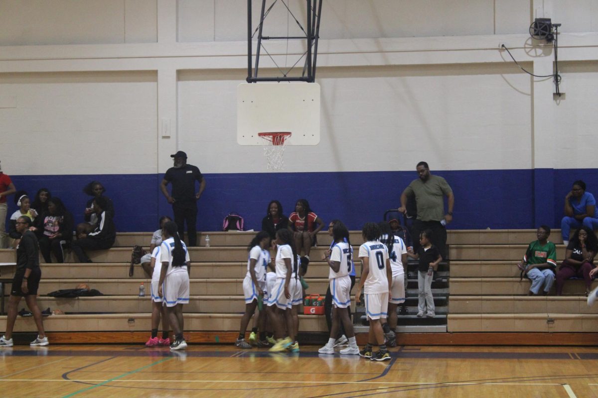 TEAMWORK: Inet Grove basketball team in a huddle to strategize their next play. 