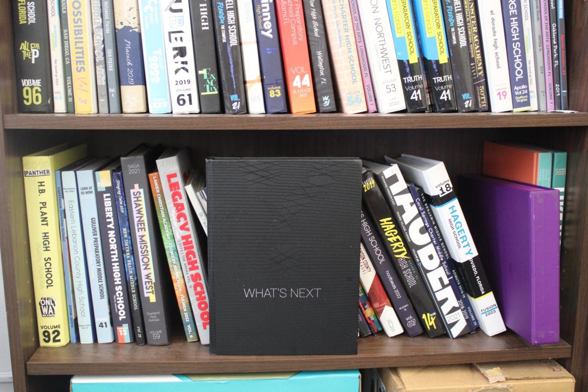 BOOKS ON DECK: Mr. Hanif exemplifies a range of creativity amongst schools by displaying their yearbooks on his shelves.
