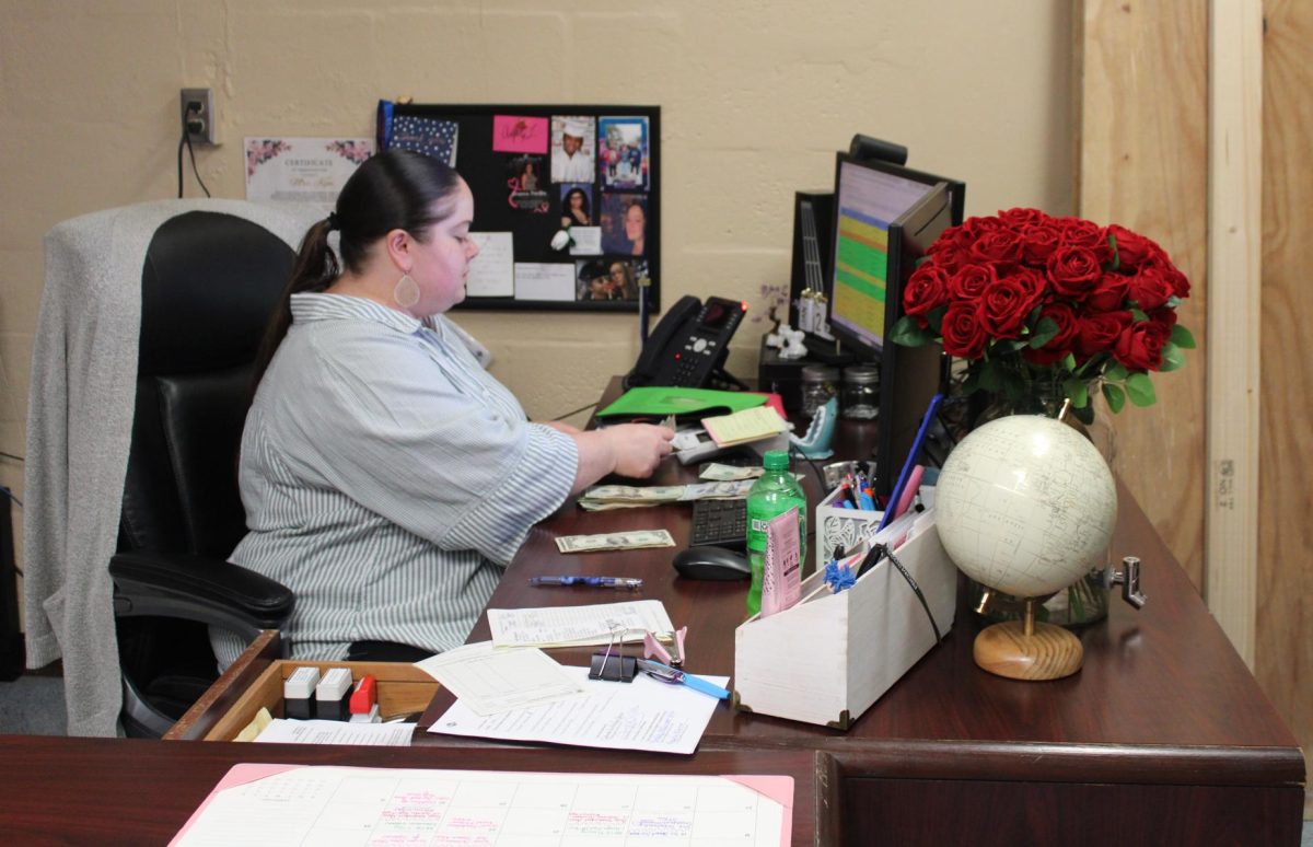 STUDENT SERVICES: Mrs. McDermott counting up student dues.